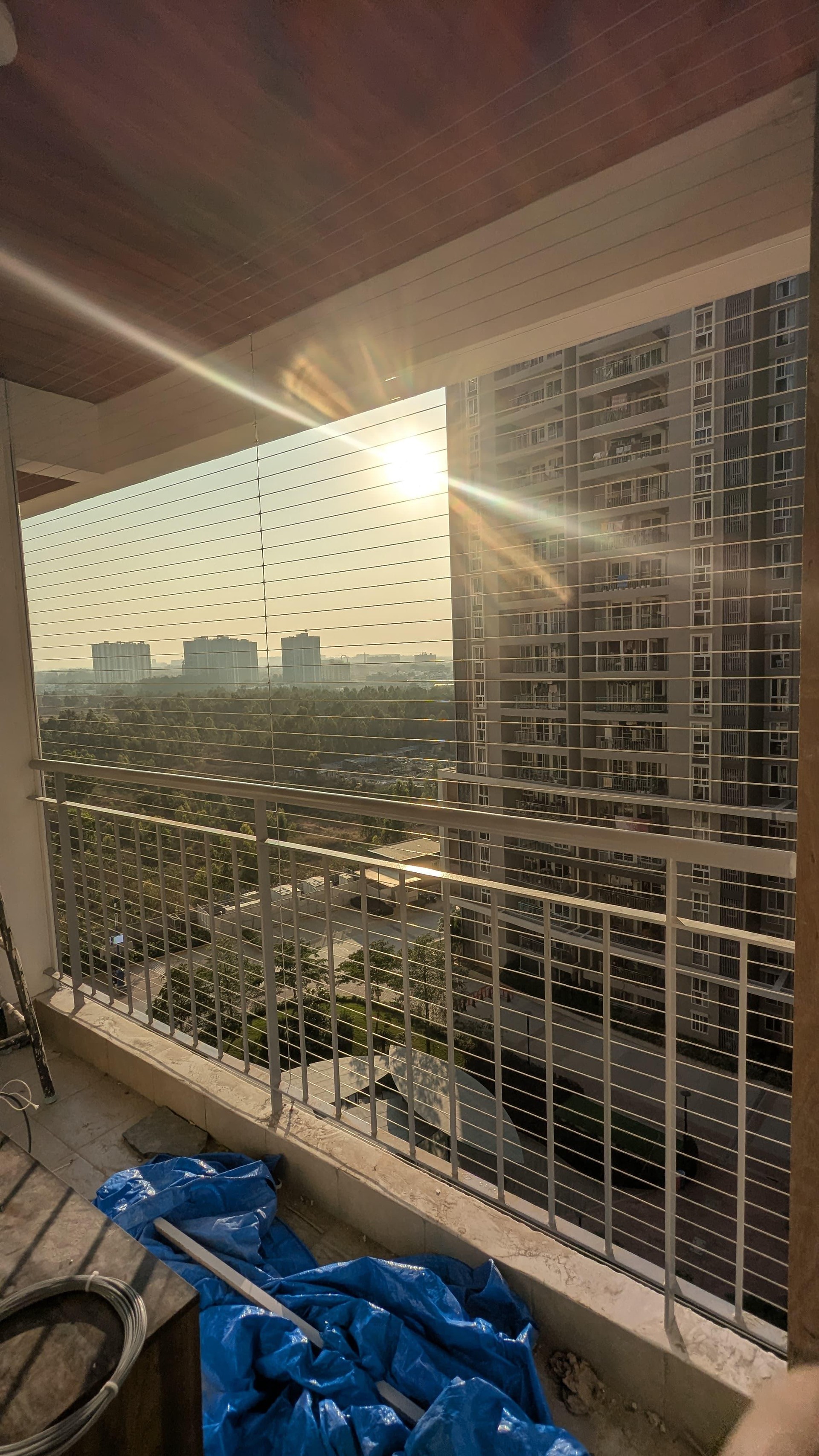 Apartment balcony at sunset – invisible grill installation by HomeNest Invisible Grills