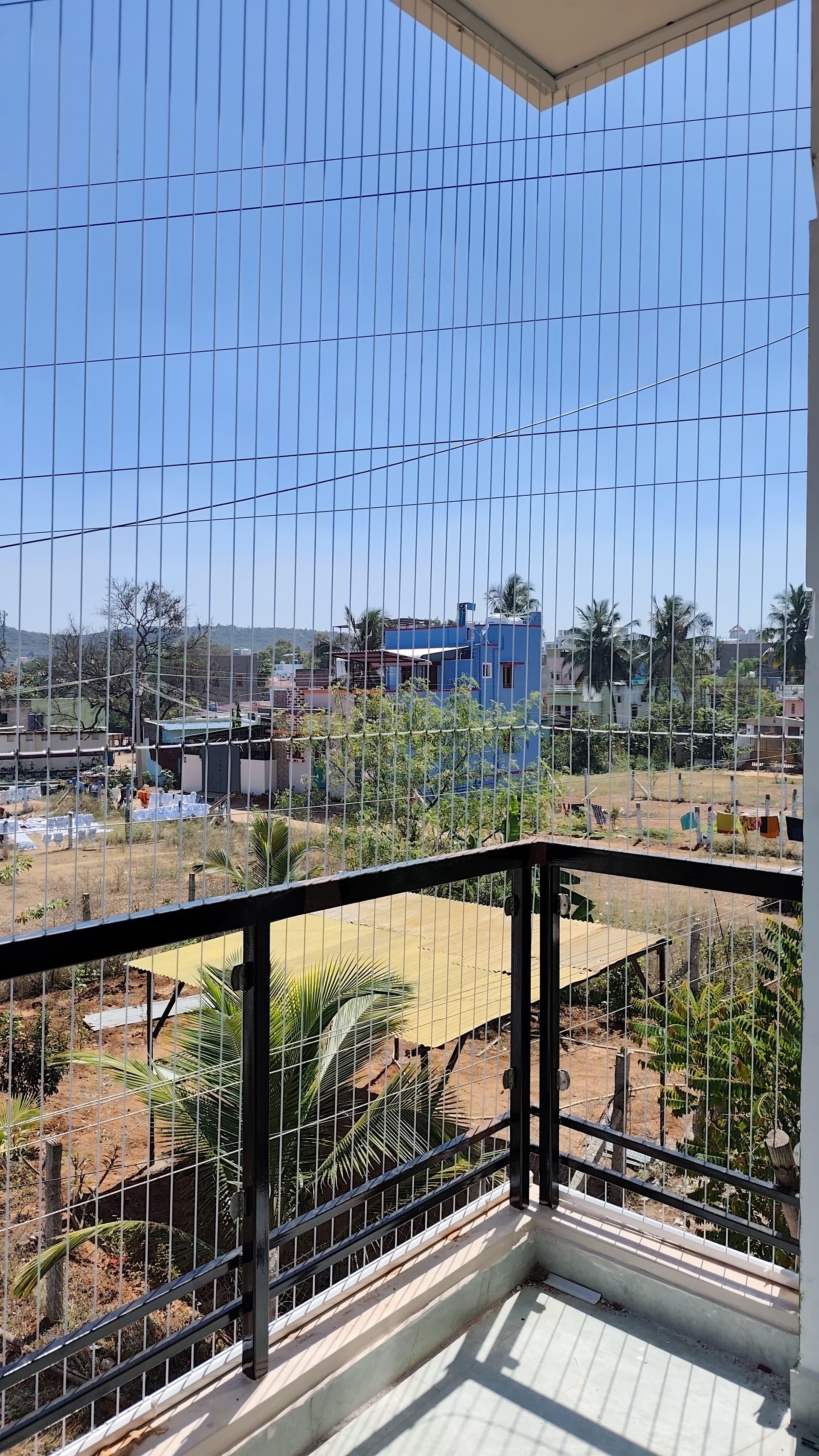Corner balcony with open view – invisible grill installation by HomeNest Invisible Grills